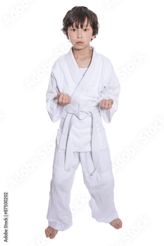 young asian boy isolated on white in judo clothing doing martial arts