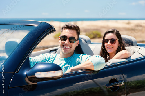 Young man with girlfriend in cabriolet.