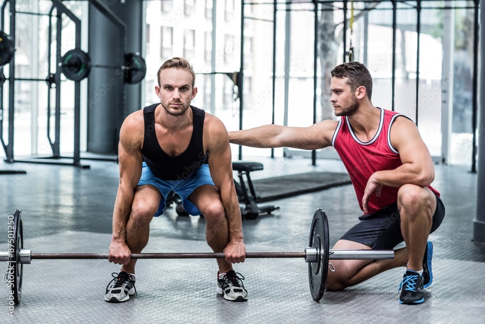 Portrait of a muscular man lifting a barbell Portrait of a muscular man lifting a barbell
