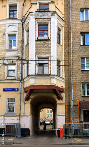 Old brick house with an archway and Bay window in the center of Moscow, Russia