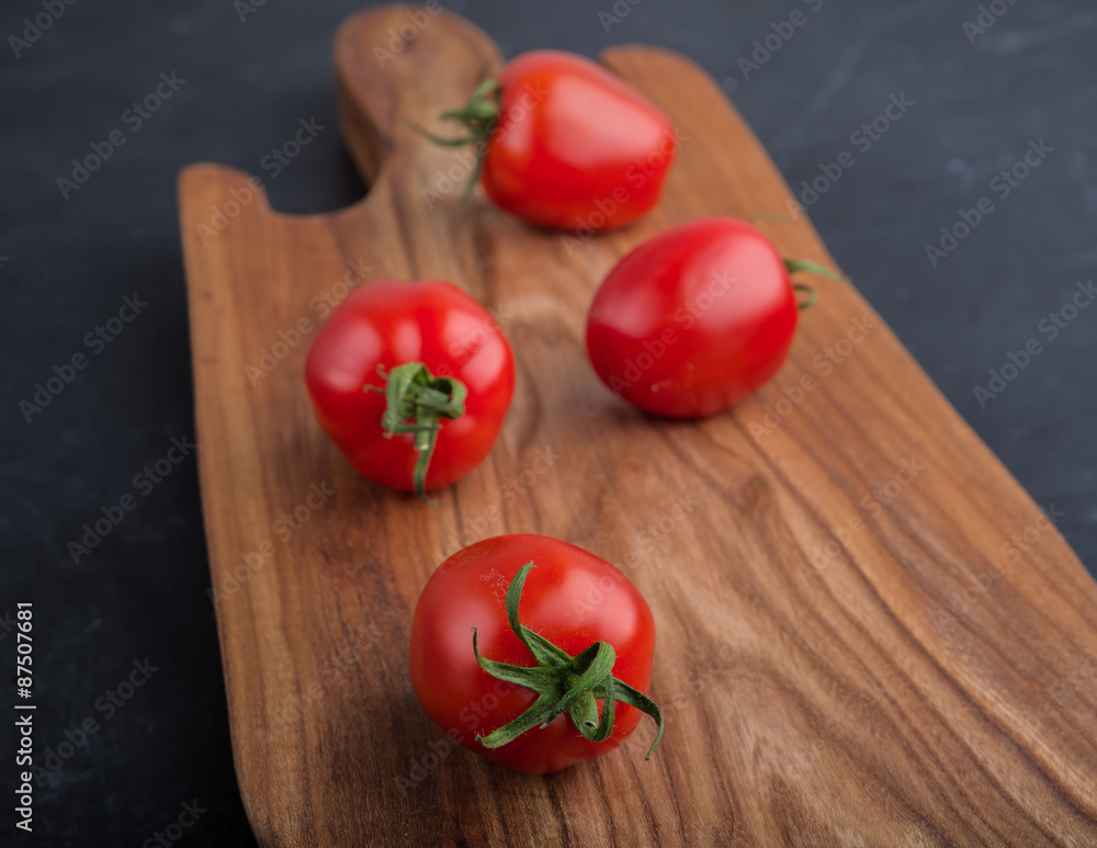 Ripe red tomatoes on cutting board Ripe red tomatoes on cutting board