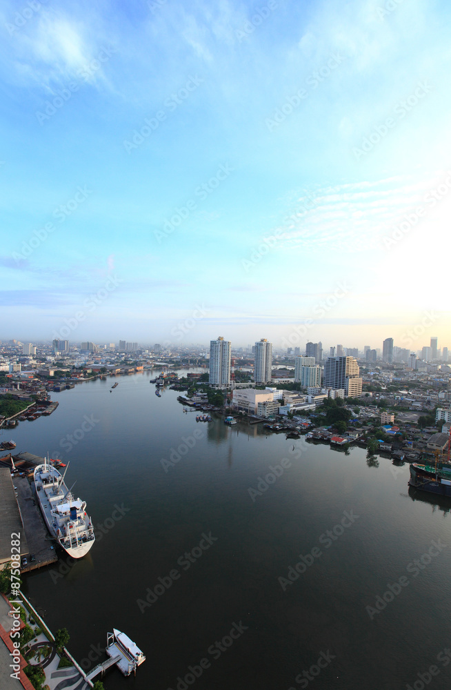 Aerial view of Bangkok Skyline along Chaophraya River at dusk wi