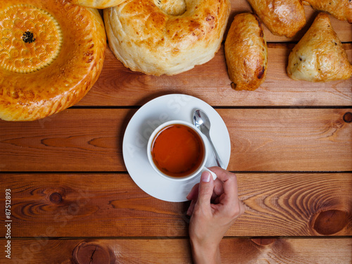 Girl drinking tea with Uzbek bread