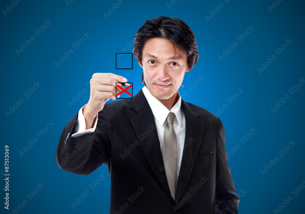 Young businessman checking mark on checklist.Not pass inspection Young businessman checking mark on checklist.Not pass inspection