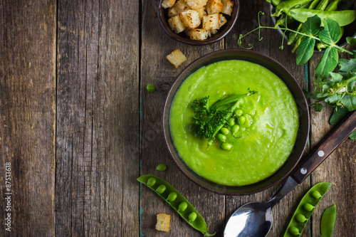 green peas soup on rustic background