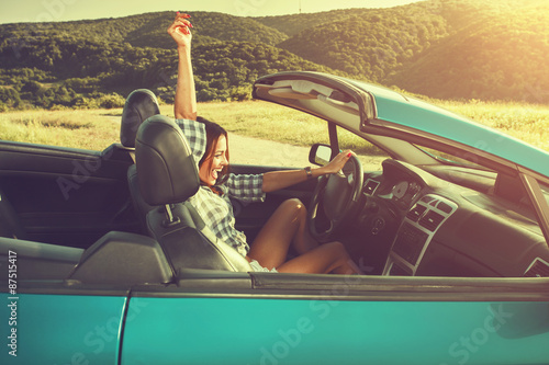 Attractive young woman in a convertible photo