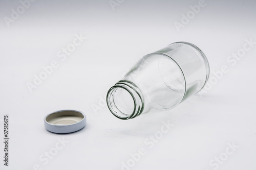 Empty colorless glass bottle on White Background