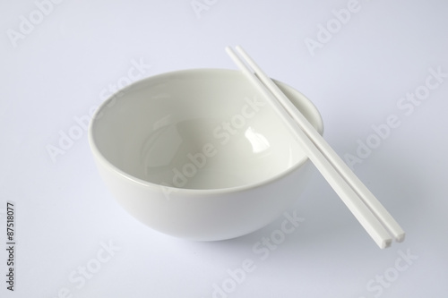 white bowl with chopsticks