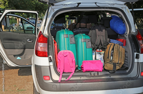 car very full with suitcases for family travel