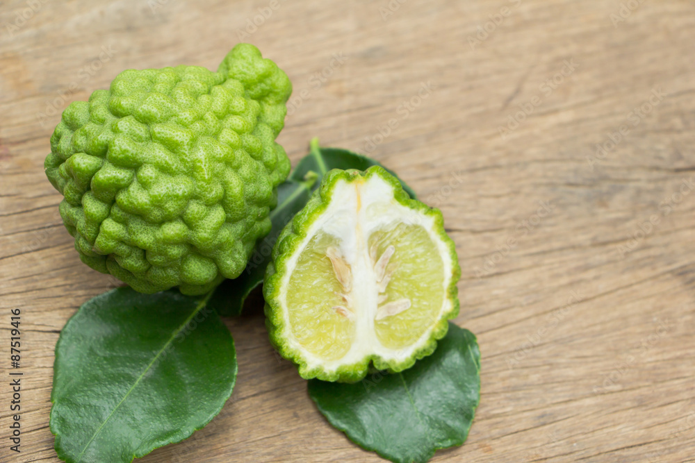 Bergamot fruit with green leafs on  wood background