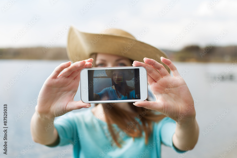 Girl in hat taking her photo Girl in hat taking her photo