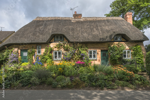 Traditional Thatched cottage in rural English countryside #87525495