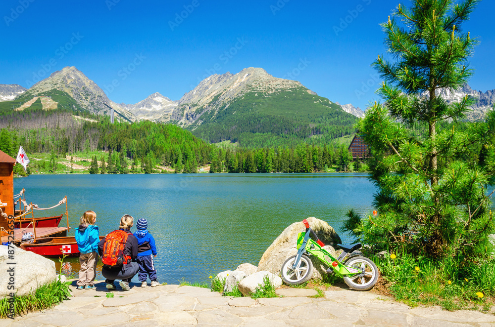 Family on bank of amazing mountain lake Family on bank of amazing mountain lake