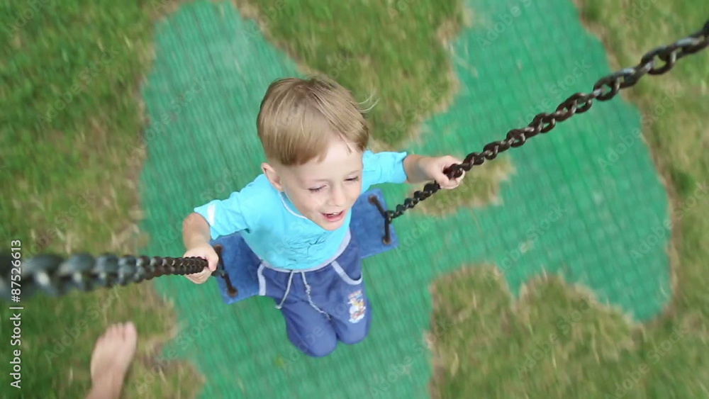 Boy riding on a swing in the park
Boy riding on a swing in the park