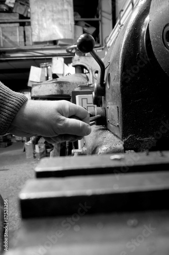 Lathe industrial man operating. Man operating an industrial lathe.