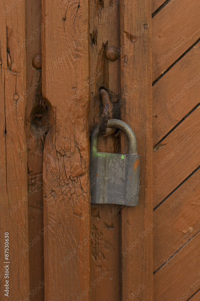 Close up of an wooden door with a lock Close up of an wooden door with a lock