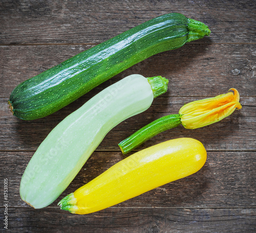 Fresh organic zucchini on the wooden table