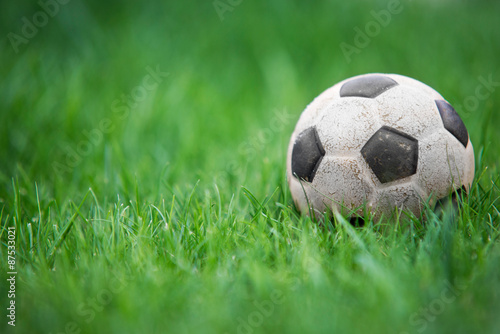 Old and classic Soccer ball or football ball on green field © irontrybex