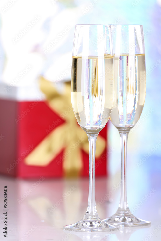 Pair glasses of champagne and present box