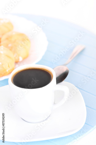 Cup of coffee on blue mat