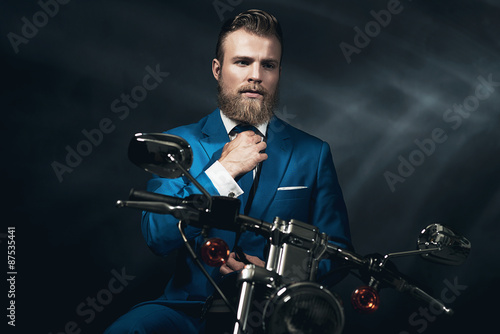 Handsome businessman on a motorbike