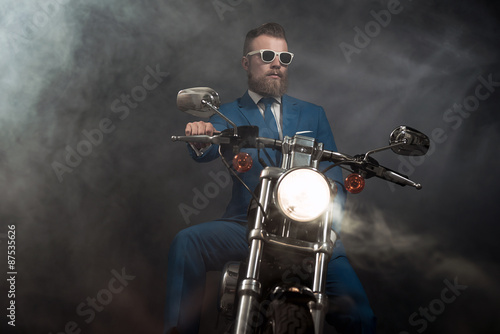 Trendy businessman on a motorbike
