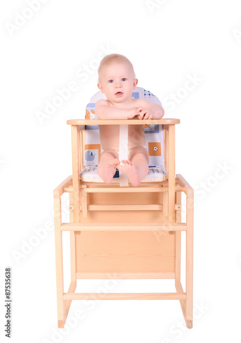 Adorable baby in high chair isolated