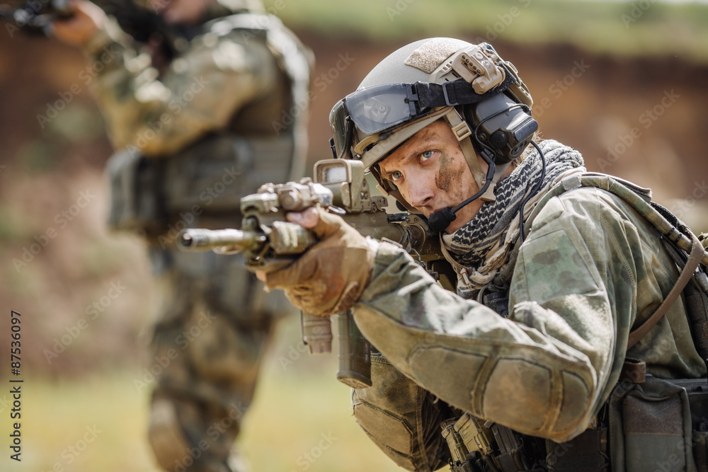 Portrait of a ranger in the battlefield with a gun Portrait of a ranger in the battlefield with a gun