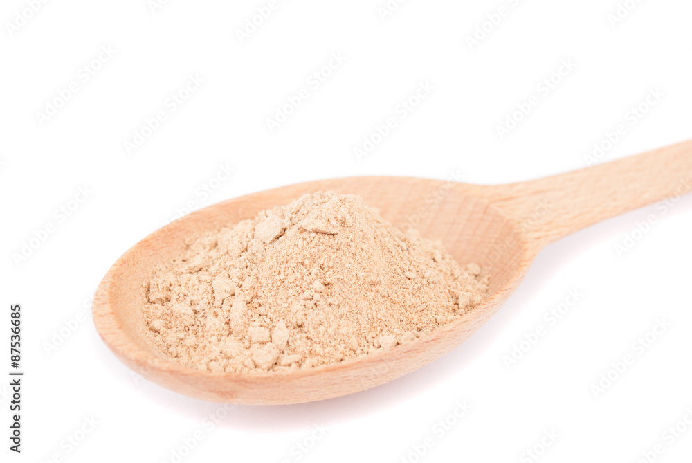 Nutmeg in a spoon isolated on white background. Nutmeg in a spoon isolated on white background.