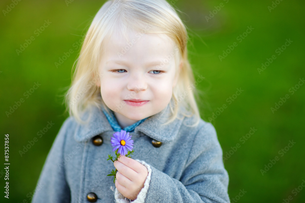 Adorable little girl holding a flower Adorable little girl holding a flower