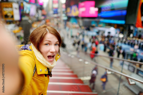 Beautiful woman taking a selfie on Times Square