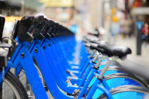 Row of city bikes for rent at docking stations © MNStudio