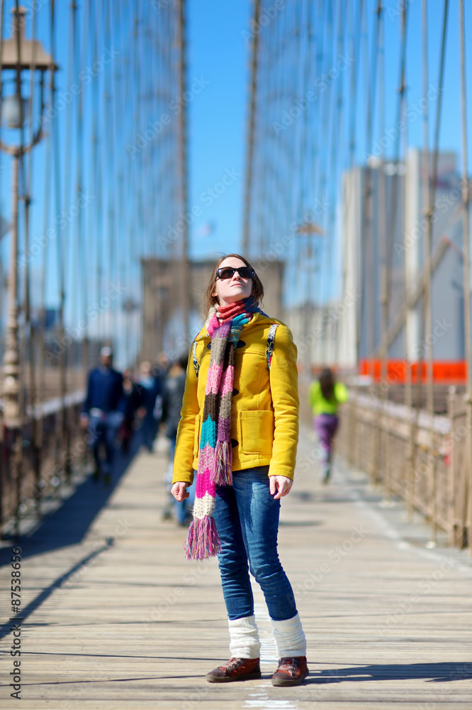 Young woman sightseeing on Brooklyn Bridge