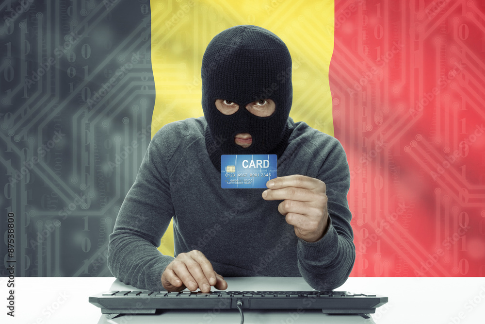 Dark-skinned hacker with flag on background holding credit card - Belgium