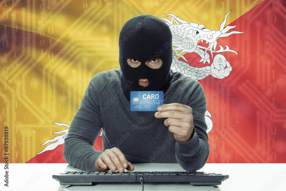 Dark-skinned hacker with flag on background holding credit card - Bhutan Dark-skinned hacker with flag on background holding credit card - Bhutan