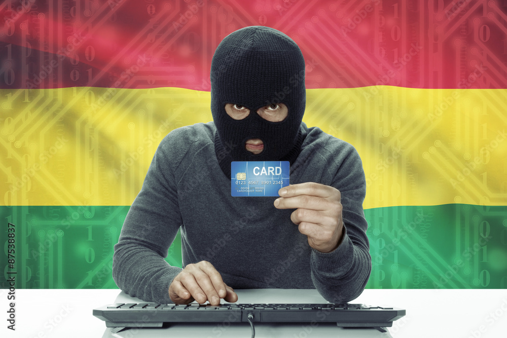 Dark-skinned hacker with flag on background holding credit card - Bolivia