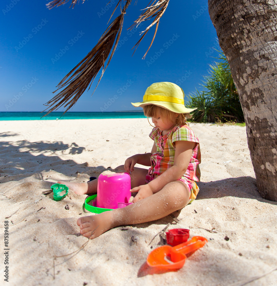 Little girl playing on the beach Little girl playing on the beach