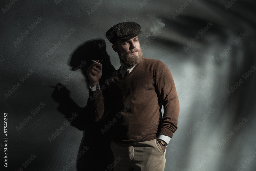 Trendy man smoking a cigarette