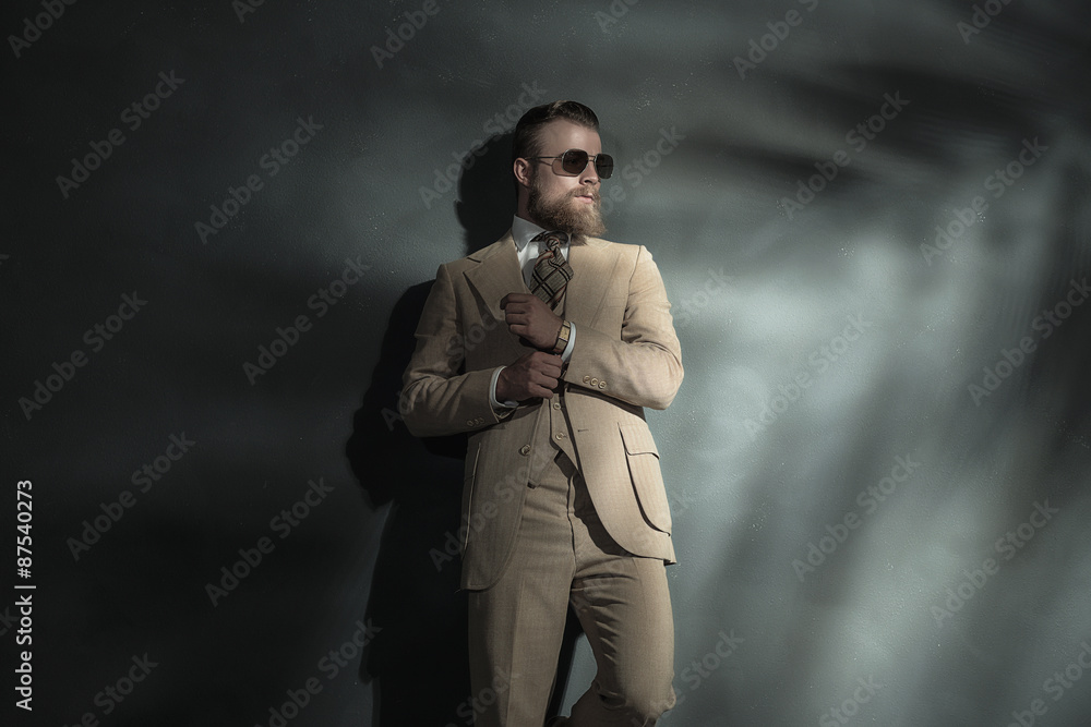 Elegant man adjusting the sleeve of his jacket Elegant man adjusting the sleeve of his jacket