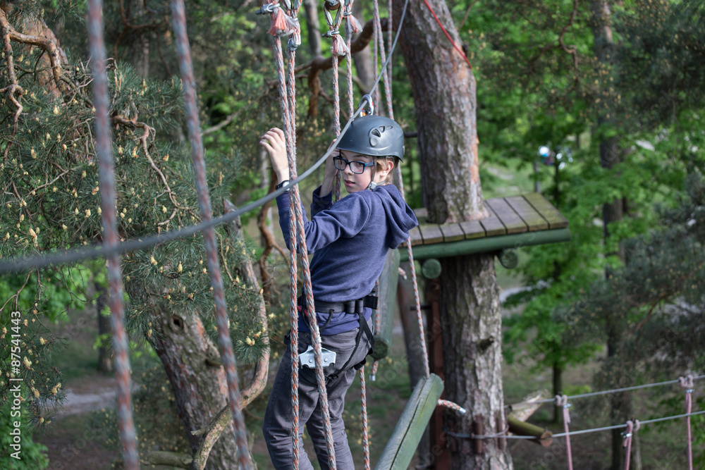 teenager climbing a rope park, Girl climbing in adventure park teenager climbing a rope park, Girl climbing in adventure park
