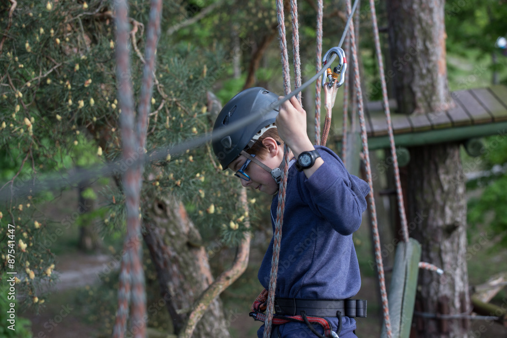 teenager climbing a rope park, Girl climbing in adventure park teenager climbing a rope park, Girl climbing in adventure park