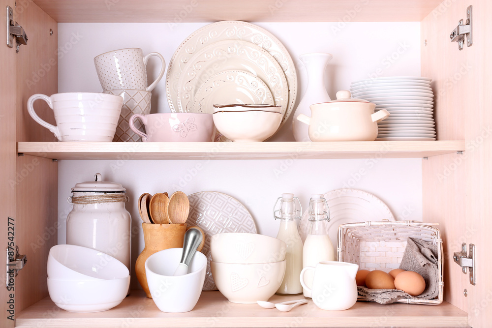 Kitchen utensils and tableware on shelves Kitchen utensils and tableware on shelves
