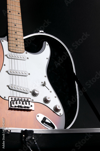 Electric guitar in guitar case, on black background