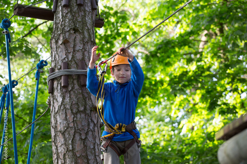 boy climbing a rope park, Girl climbing in adventure park 