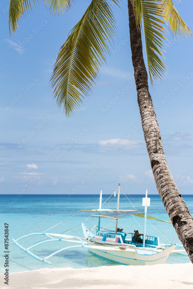 Wooden boat on tropical beach