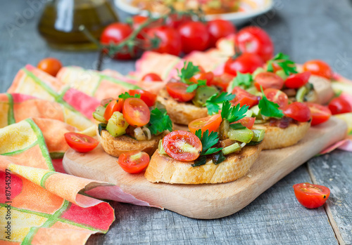 Bruschetta with zucchini, bacon, green onions and cherry tomatoe