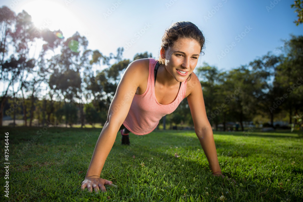 Woman exercising in nature natural smile happy and strong on grass field sunny day