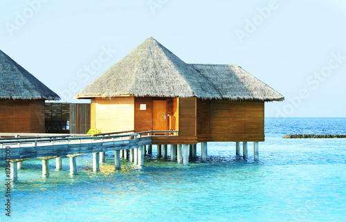 Water villas over ocean background, in resort © Africa Studio
