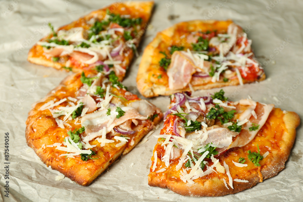 Tasty pizza on paper close up Tasty pizza on paper close up