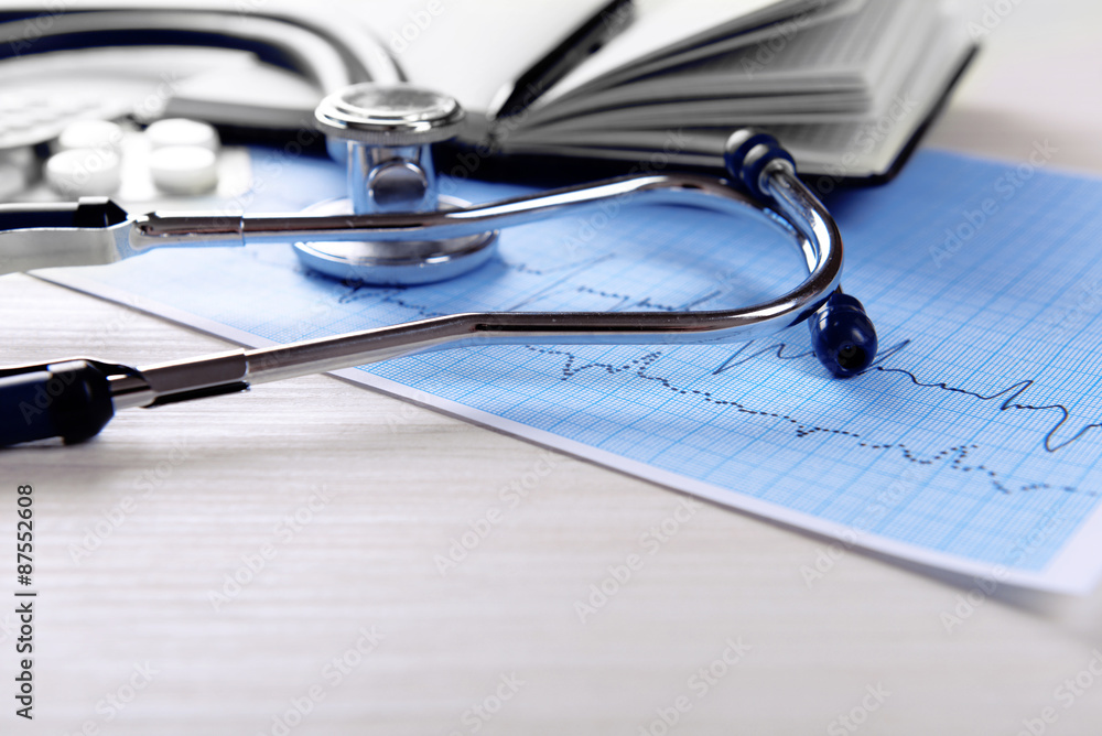 Cardiogram with stethoscope on table, closeup Cardiogram with stethoscope on table, closeup